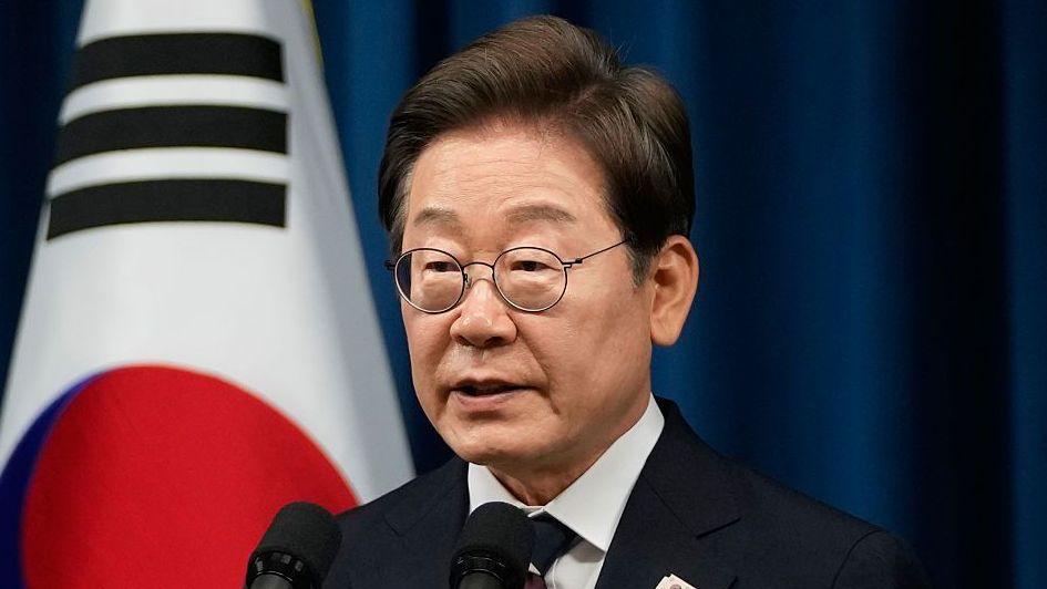 South Korean President Lee speaking at a podium