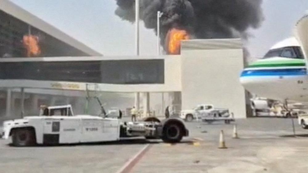 Smoke and flames rise from King Khalid Airport after a Houthi drone attack in Riyadh