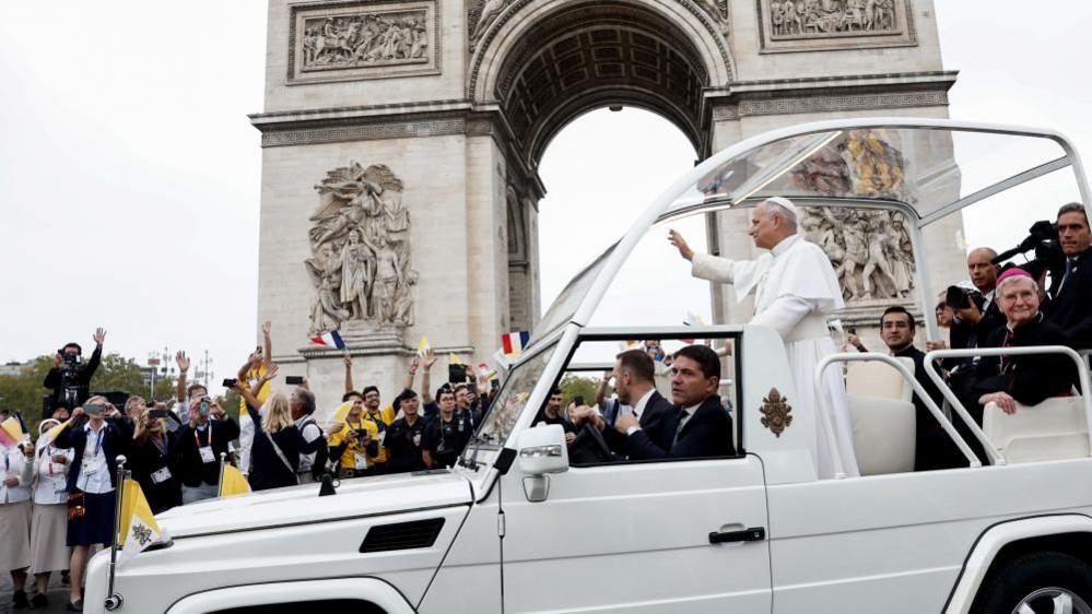 Pope in popemobile on Champs‑Élysées