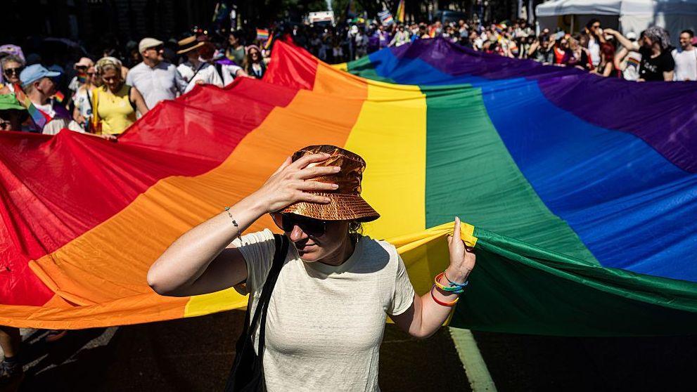 Attendees with a giant rainbow flag during the Budapest Pride march