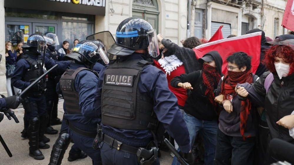 Firefighters fighting burning barricades during French school protests