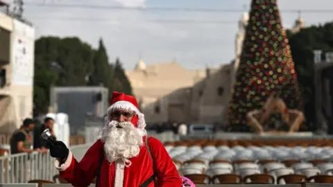 A Spark of Hope: Bethlehem Lights Up for Christmas Amid Gaza War's Shadows