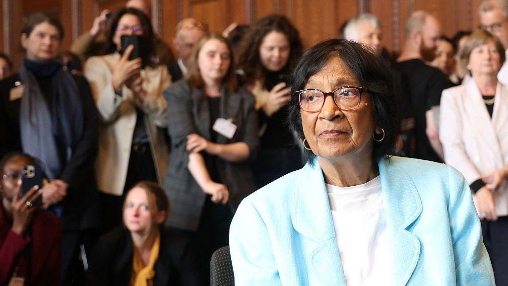Navi Pillay in a sky blue jacket