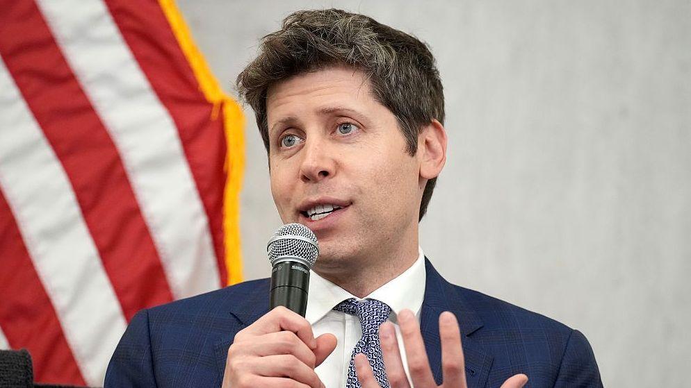 OpenAI CEO Sam Altman in front of an American flag