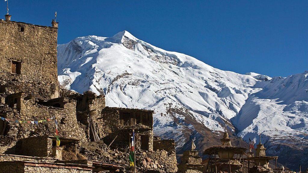 The peaks of Himlung Himal rising over a Nepali village