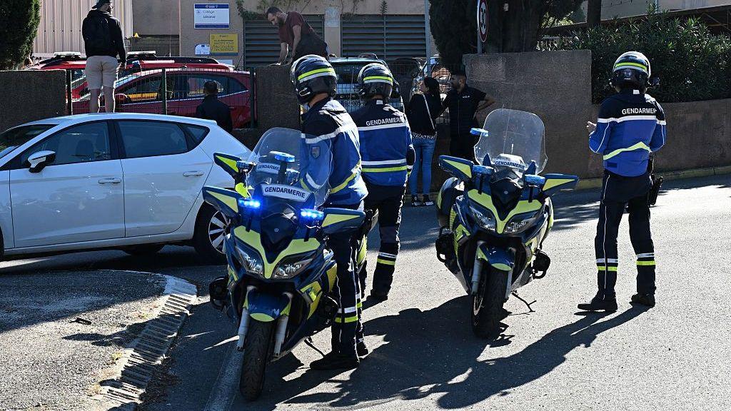 Two staff members shot at French school
